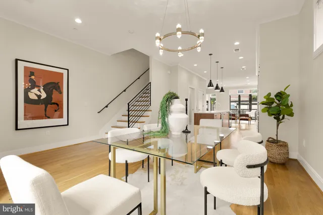 a large kitchen with kitchen island a sink a center island stainless steel appliances and a counter top space