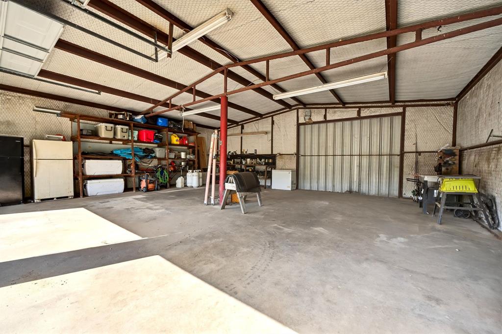 1334 Private Road Van, TX 75790 - Photo 26 of 32 Concrete Slab, bright lights, and a large sliding door in the back.