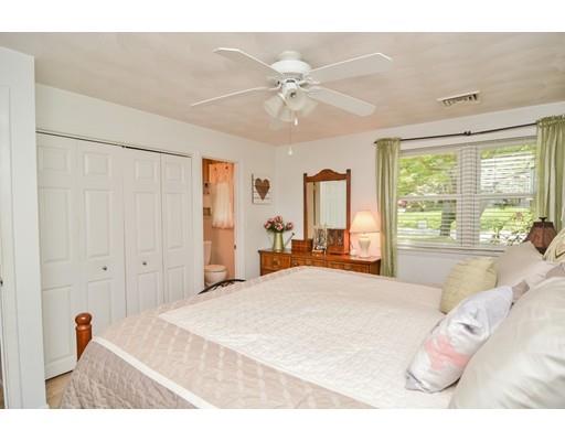 17 Ruthellen Road Chelmsford, MA 01824 - Photo 23 of 42 a bedroom with a large bed and a chandelier