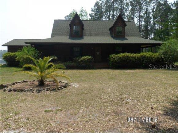 7550 Northeast 199th Street Road Citra, FL 32113 - Photo 1 of 1 a view of a back yard of the house