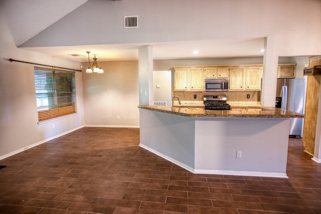 308 County Road 893B Angleton, TX 77515 - Photo 15 of 41 a kitchen with granite countertop a sink and cabinets