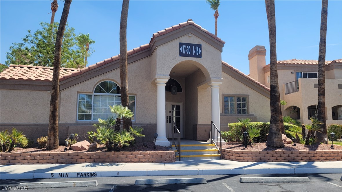 1851 Hillpointe Road, Unit 1022 Henderson, NV 89074 - Photo 4 of 8 A terracotta-tiled roof and archway entrance define this desert-inspired community building.