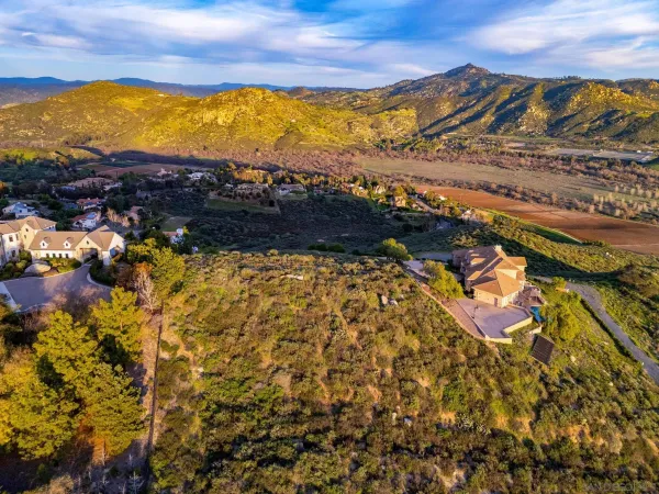 an aerial view of a houses with a lake view