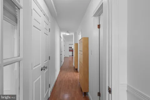 a view of hallway with wooden floor