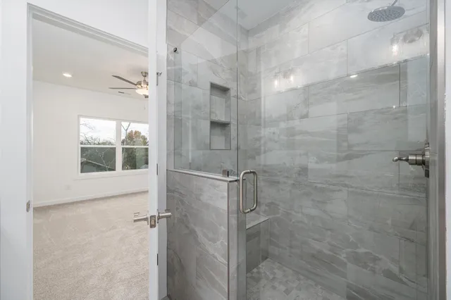a bathroom with a glass shower door