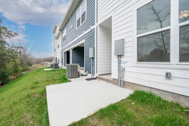 a view of a house with a backyard and porch