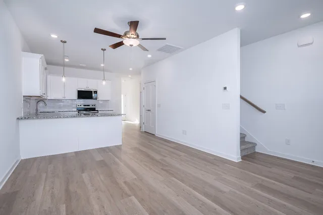 a view of kitchen with refrigerator stove and a ceiling fan