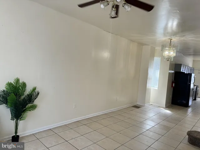 an empty room with potted plants