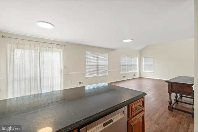 a view of workspace with a window and wooden floor