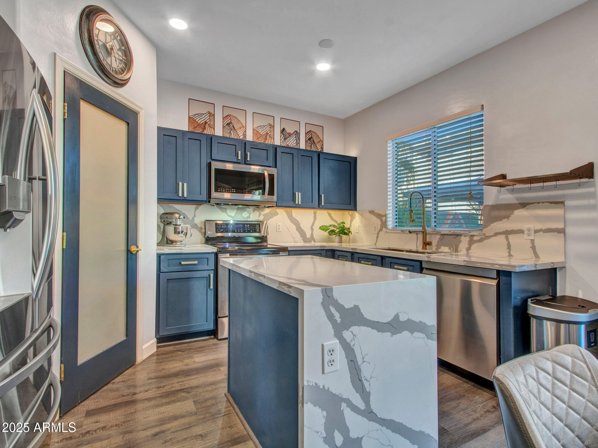 4122 West Carter Road Phoenix, AZ 85041 - Photo 3 of 7 a kitchen with stainless steel appliances granite countertop a refrigerator a stove top oven a sink and dishwasher