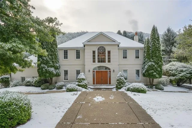 a front view of a house with a yard and a garage