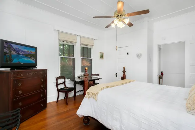 a bedroom with a bed and a flat screen tv