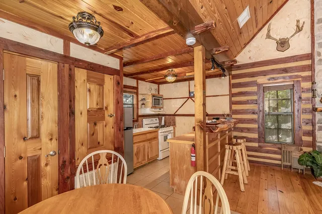 a view of a dining room with furniture wooden floor and a chandelier
