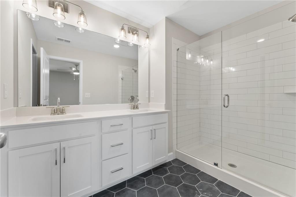 4659 Larkfield Way, Unit 15 Powder Springs, GA 30127 - Photo 17 of 60 a bathroom with a double vanity sink mirror and shower