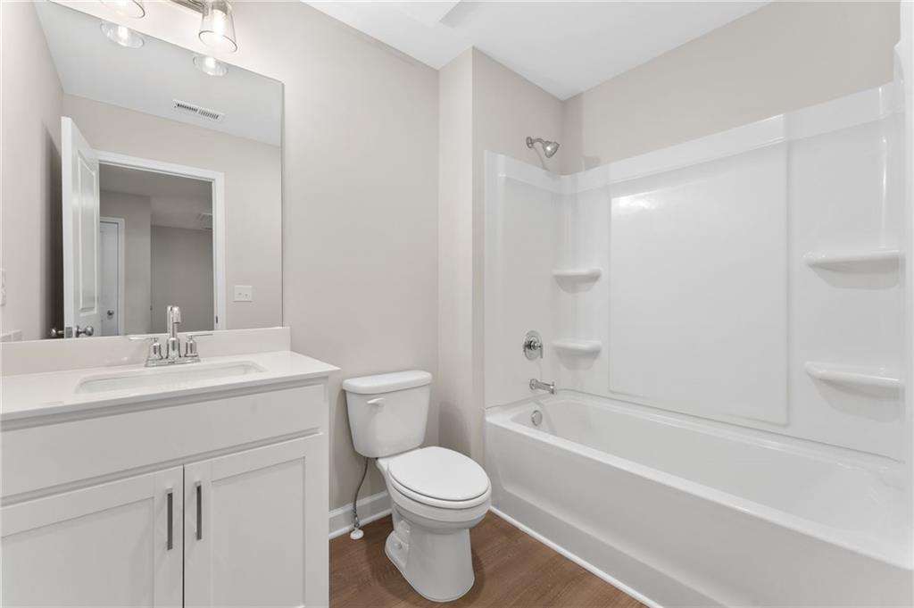 4659 Larkfield Way, Unit 15 Powder Springs, GA 30127 - Photo 22 of 60 a bathroom with a toilet a sink and a bathtub