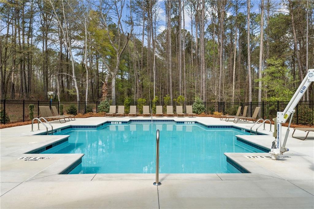 4659 Larkfield Way, Unit 15 Powder Springs, GA 30127 - Photo 29 of 60 a swimming pool with outdoor seating and yard