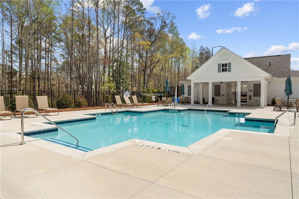 4659 Larkfield Way, Unit 15 Powder Springs, GA 30127 - Photo 30 of 60 a front view of a house with a yard table and chairs