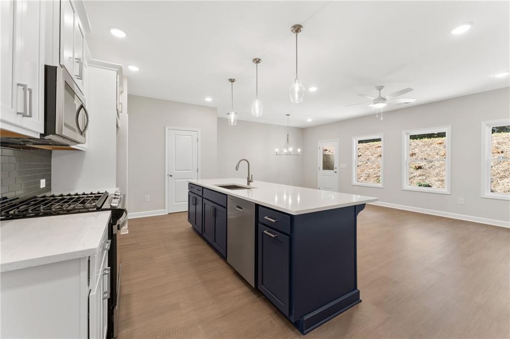 4659 Larkfield Way, Unit 15 Powder Springs, GA 30127 - Photo 5 of 60 a kitchen with stainless steel appliances granite countertop a sink a stove and a refrigerator