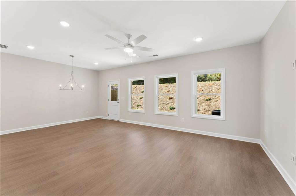 4659 Larkfield Way, Unit 15 Powder Springs, GA 30127 - Photo 6 of 60 an empty room with windows and ceiling fan