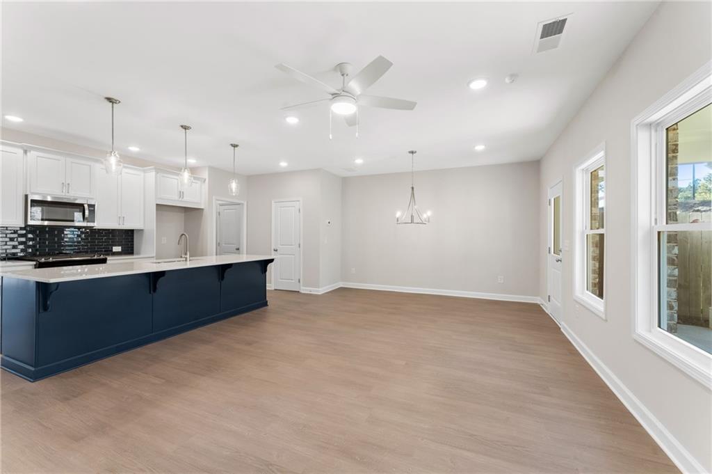 4659 Larkfield Way, Unit 15 Powder Springs, GA 30127 - Photo 7 of 60 a large kitchen with kitchen island granite countertop a large window