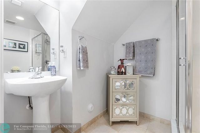 a bathroom with a sink a mirror and glass door