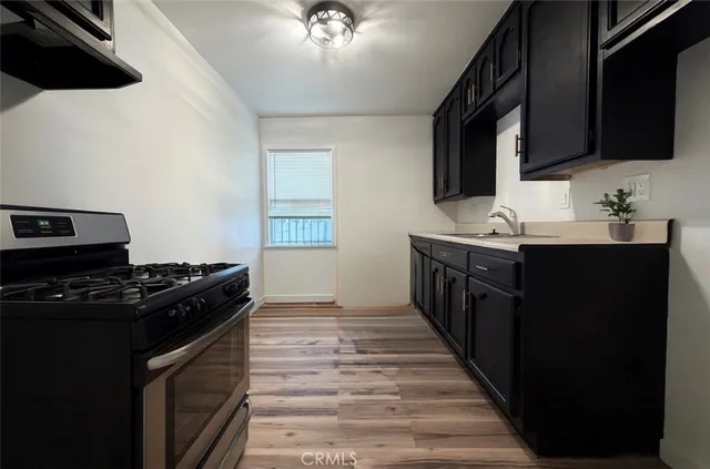 a kitchen with a sink stove and microwave