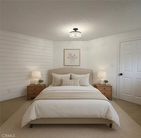 a bedroom with a bed and a lamp