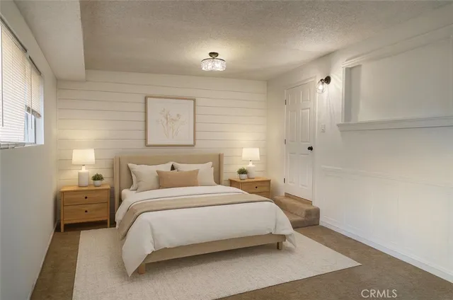 a bedroom with a bed and a night stand