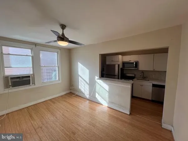a kitchen with kitchen island granite countertop a sink cabinets and stainless steel appliances