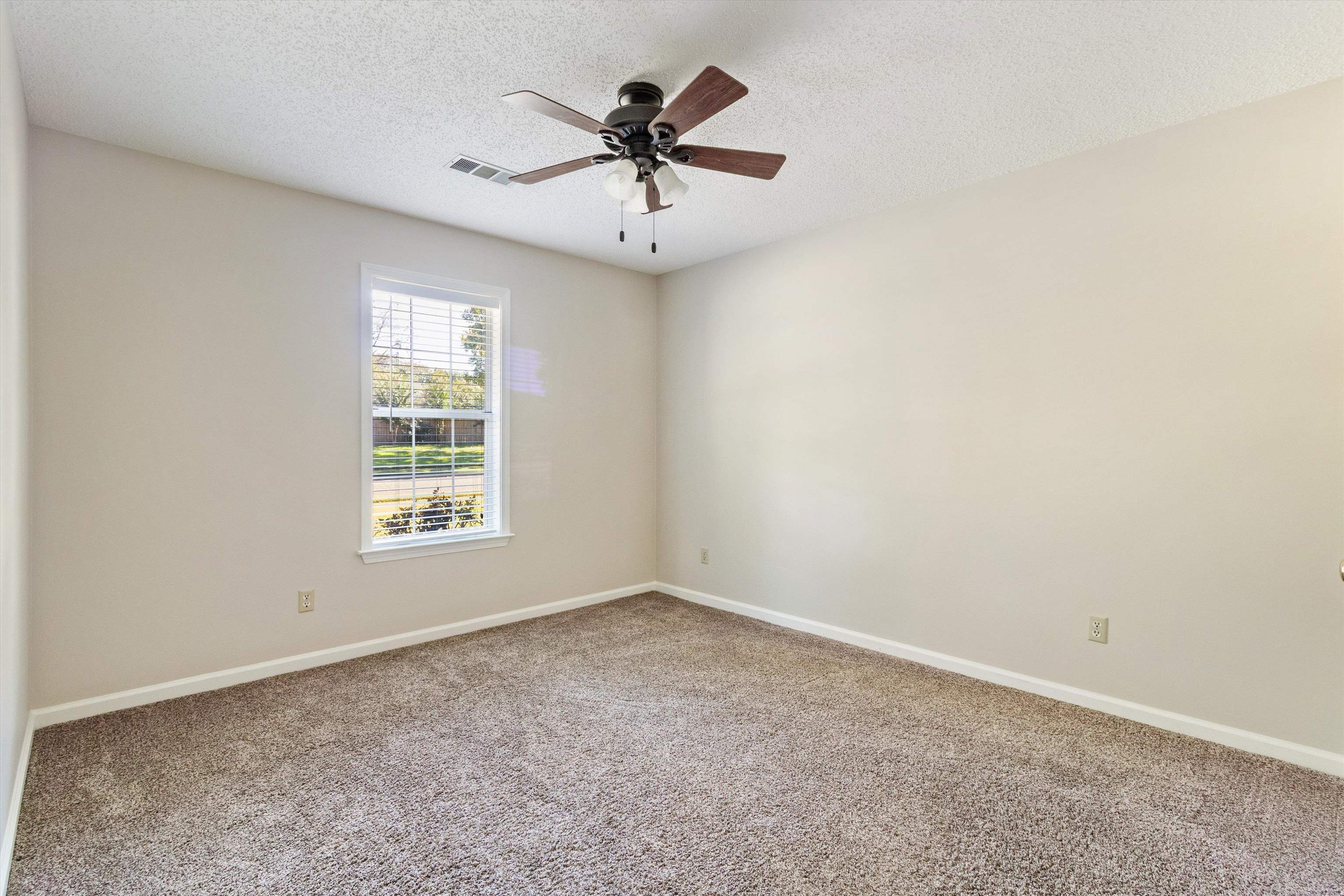 465 Harts Way Drive Collierville, TN 38017 - Photo 19 of 29 an empty room with a window and a ceiling fan