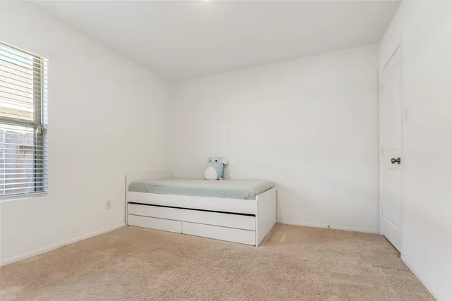 a white room with a white bed