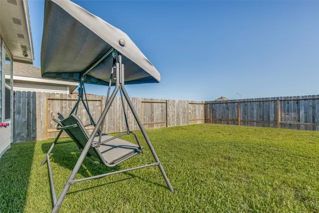 a view of a backyard with a table and chairs
