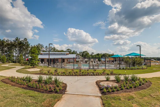 a view of a swimming pool and a yard
