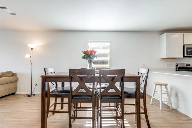 a view of a dining room with furniture and wooden floor