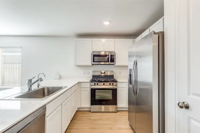 a kitchen with a sink stove and refrigerator