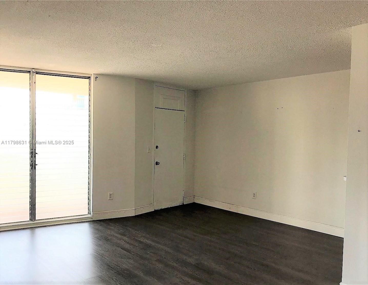 1100 Alton Road, Unit 3D Miami Beach, FL 33139 - Photo 11 of 14 a view of an empty room and wooden floor