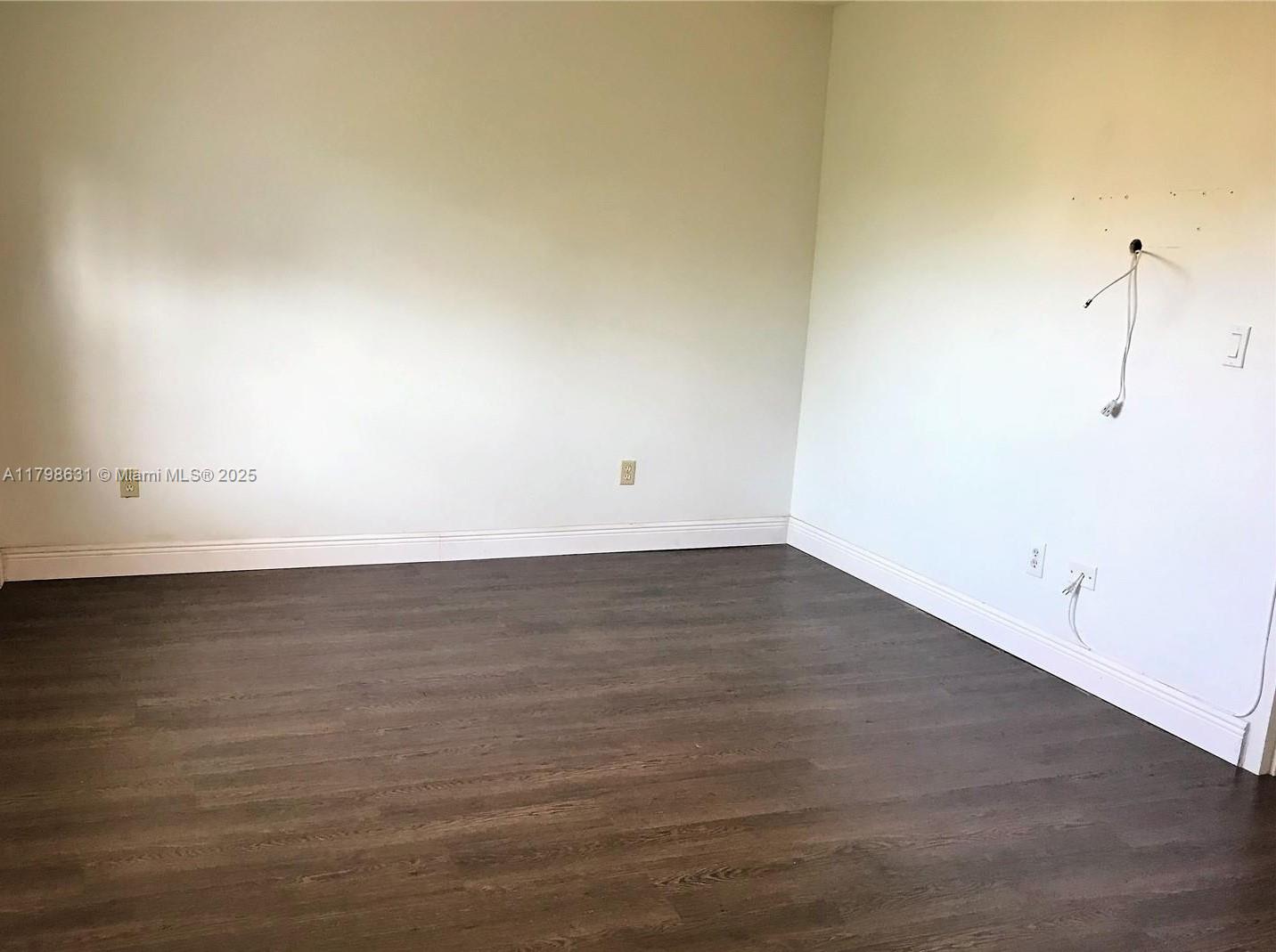1100 Alton Road, Unit 3D Miami Beach, FL 33139 - Photo 10 of 14 a view of an empty room with wooden floor