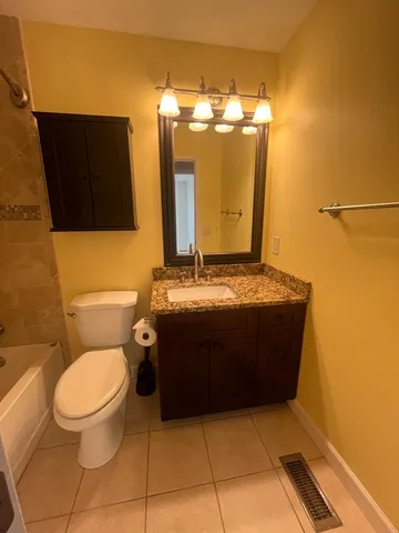 a bathroom with a toilet and a mirror
