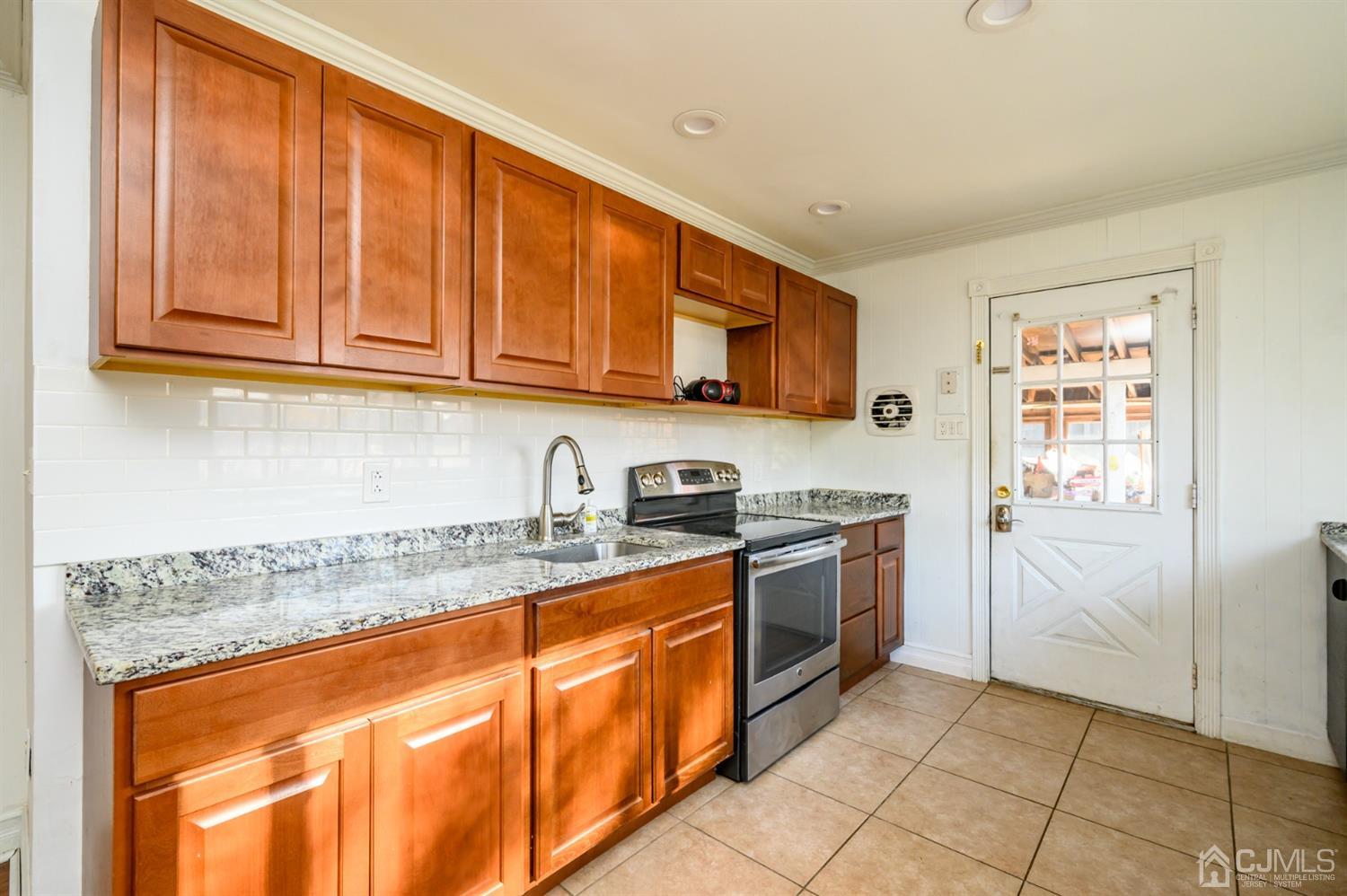 317 Maple Road Mount Laurel, NJ 08054 - Photo 12 of 38 a kitchen with stainless steel appliances granite countertop a stove a sink and a microwave