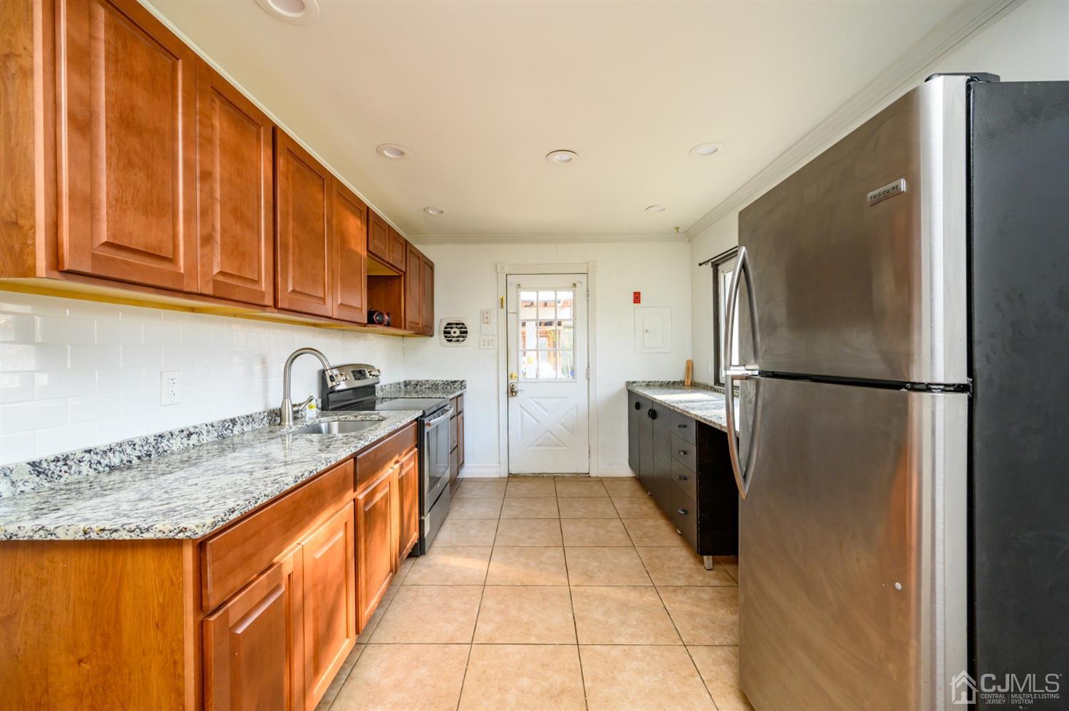 317 Maple Road Mount Laurel, NJ 08054 - Photo 15 of 38 a kitchen with granite countertop a refrigerator and a sink