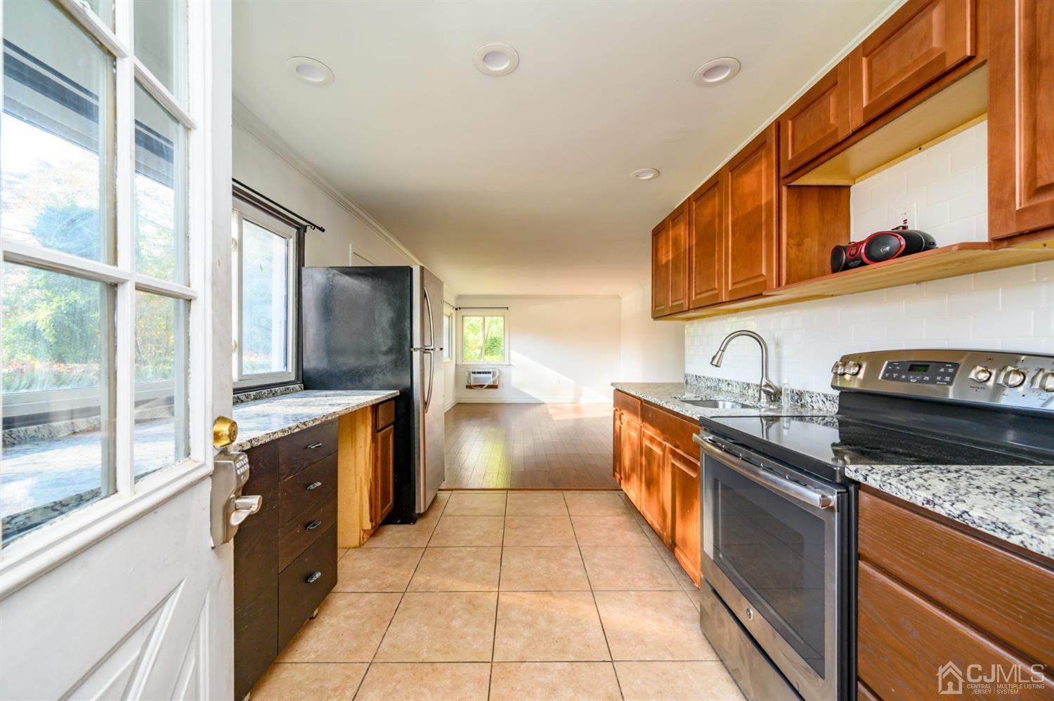 317 Maple Road Mount Laurel, NJ 08054 - Photo 16 of 38 a large kitchen with stainless steel appliances granite countertop a stove and a sink