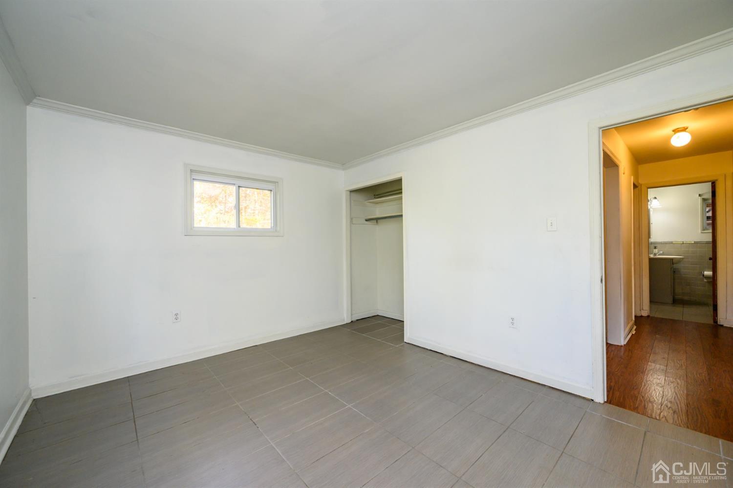 317 Maple Road Mount Laurel, NJ 08054 - Photo 18 of 38 an empty room with wooden floor and a hallway
