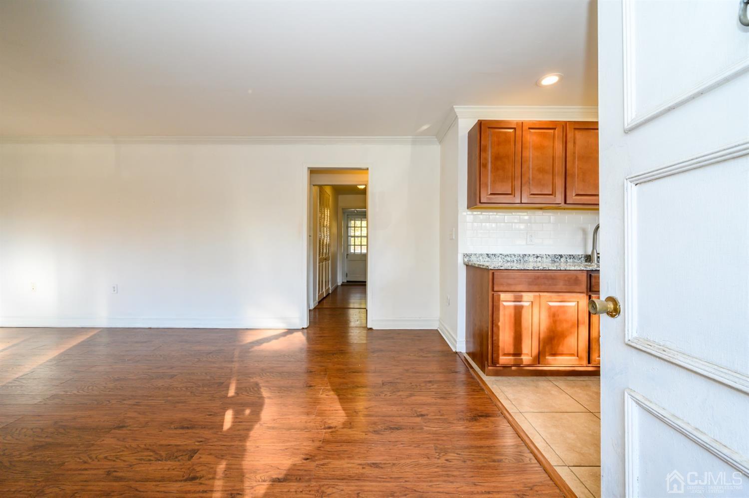 317 Maple Road Mount Laurel, NJ 08054 - Photo 3 of 38 a view of empty room with wooden floor and fan