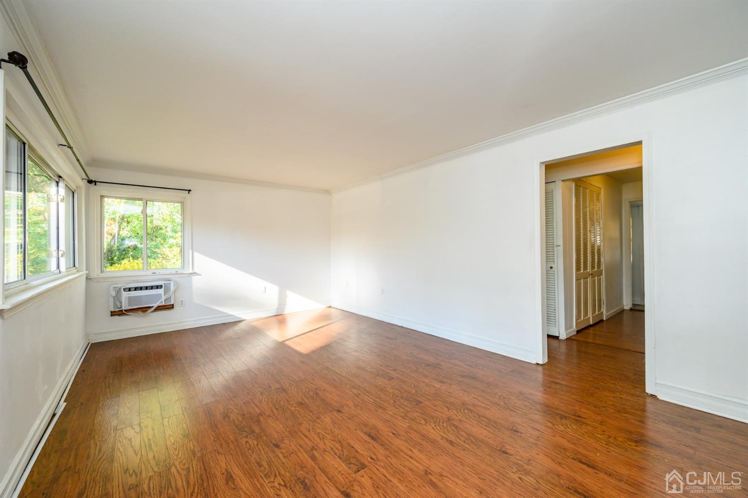 317 Maple Road Mount Laurel, NJ 08054 - Photo 4 of 38 an empty room with wooden floor and windows
