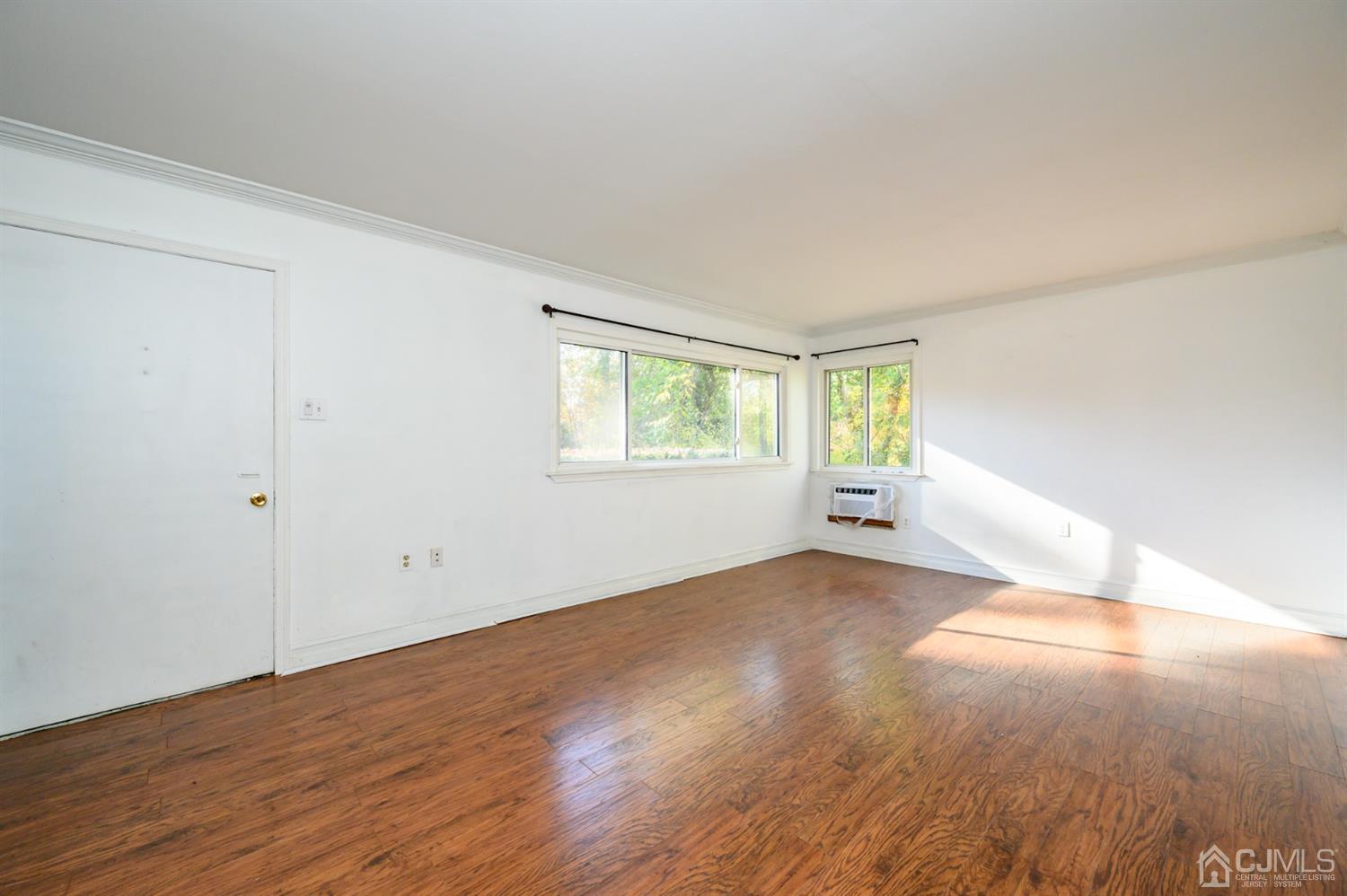 317 Maple Road Mount Laurel, NJ 08054 - Photo 5 of 38 an empty room with wooden floor and windows