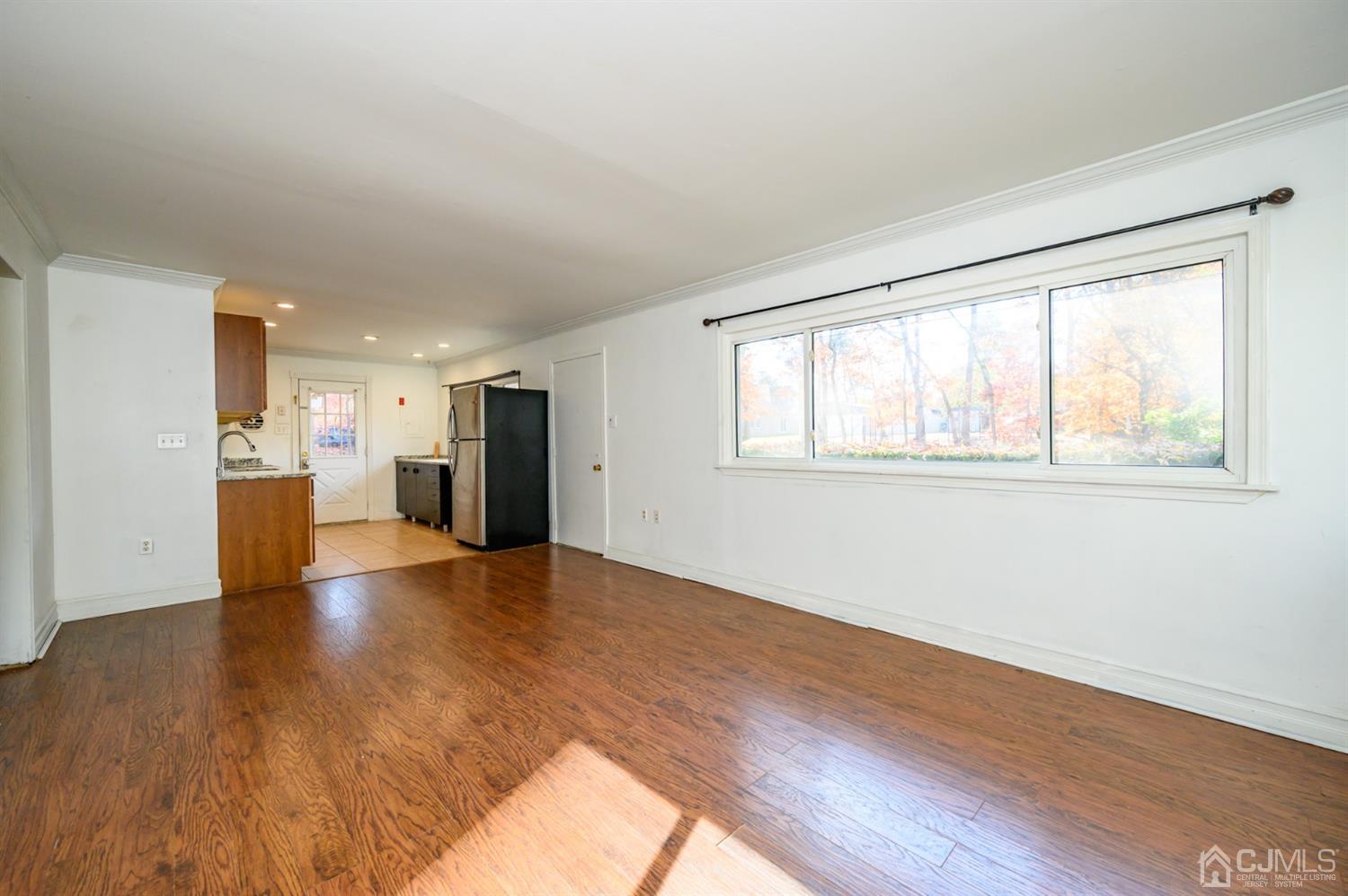 317 Maple Road Mount Laurel, NJ 08054 - Photo 6 of 38 a view of an empty room with wooden floor and a window