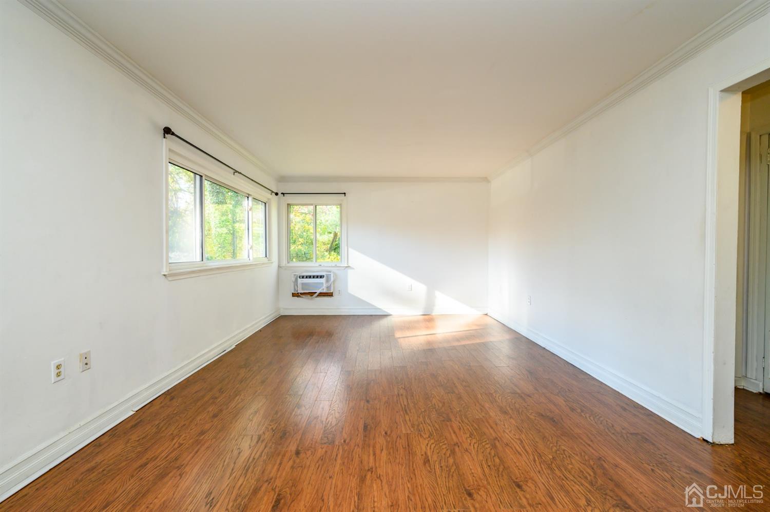 317 Maple Road Mount Laurel, NJ 08054 - Photo 9 of 38 an empty room with wooden floor and windows