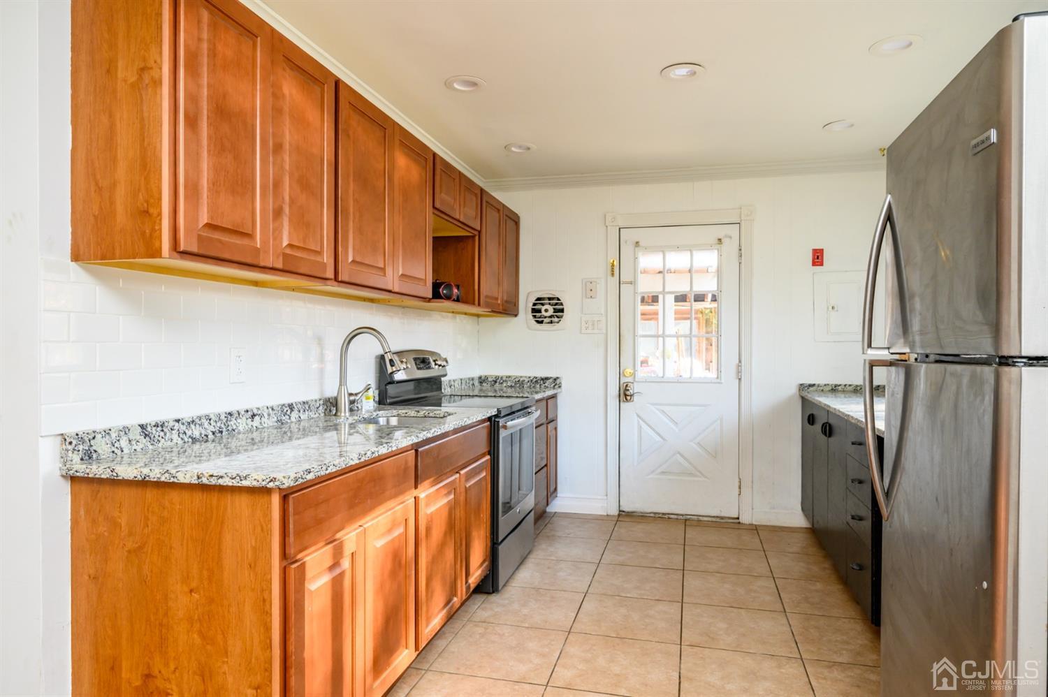 317 Maple Road Mount Laurel, NJ 08054 - Photo 10 of 38 a kitchen with a sink refrigerator and cabinets
