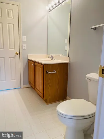 a bathroom with a sink a toilet and mirror