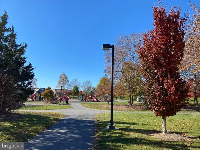 a view of a roof deck with couches and sky view